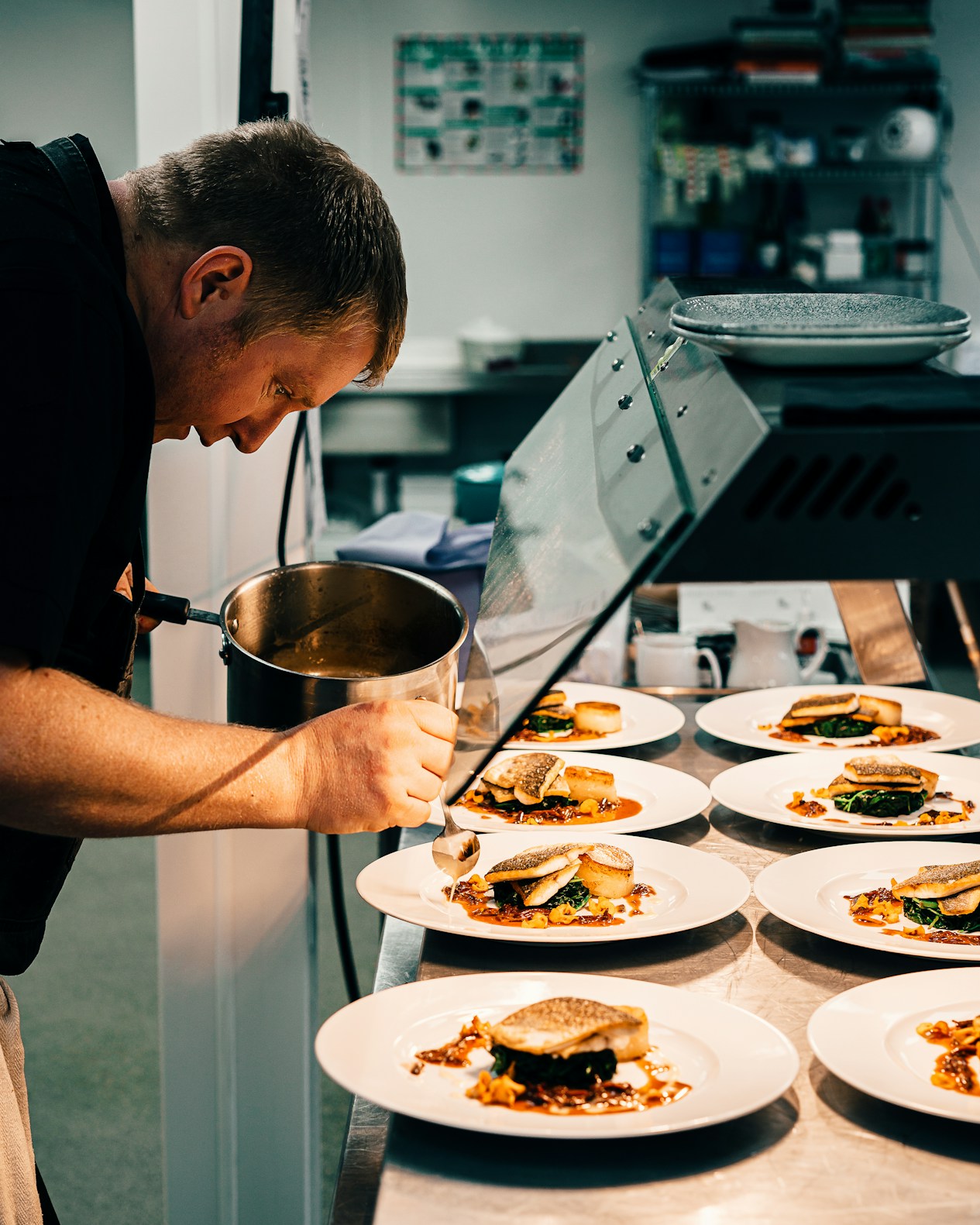 Chef plating dishes at the pass